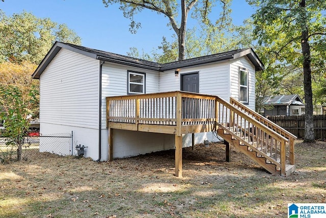 rear view of property with a wooden deck