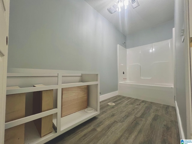 bathroom featuring hardwood / wood-style flooring and tub / shower combination