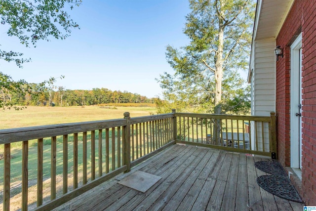 wooden deck featuring a yard