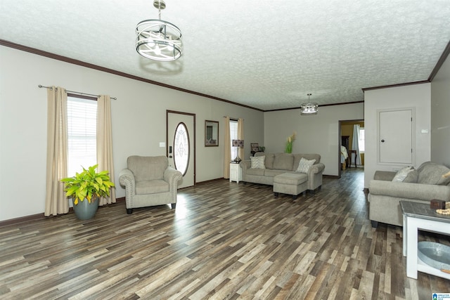 living room with an inviting chandelier, a textured ceiling, ornamental molding, and wood finished floors