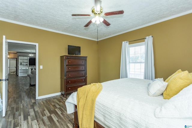 bedroom featuring dark wood-style flooring, crown molding, a textured ceiling, and baseboards