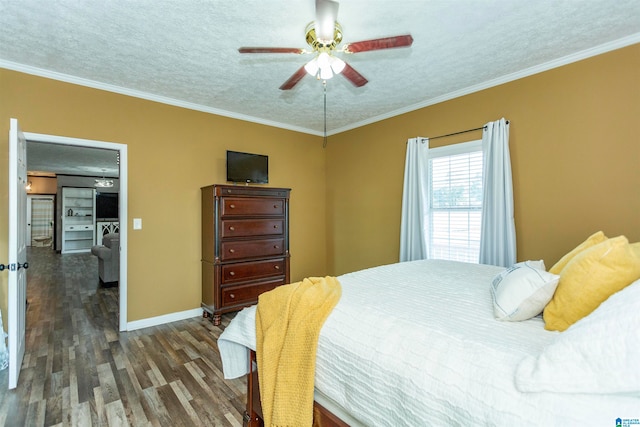 bedroom with ornamental molding, dark hardwood / wood-style floors, a textured ceiling, and ceiling fan