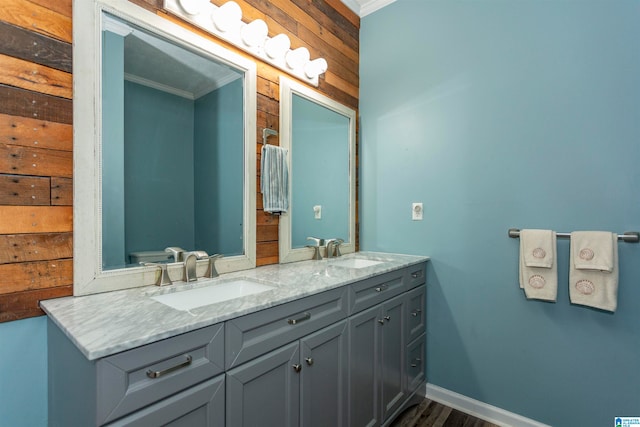 bathroom with vanity, crown molding, and hardwood / wood-style floors