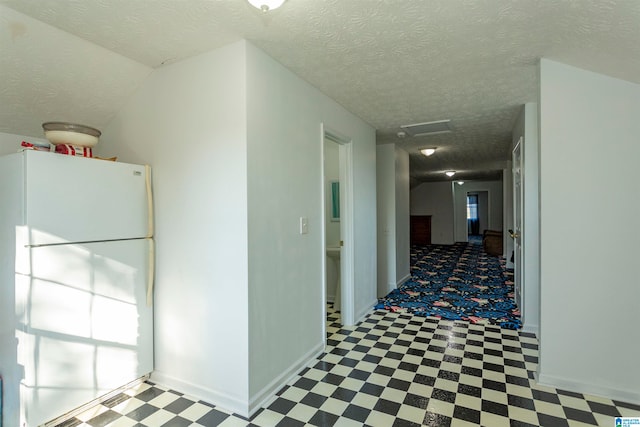 hallway with a textured ceiling