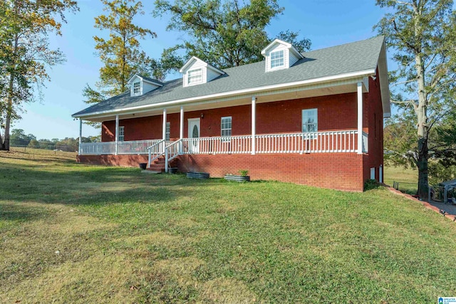 new england style home with a front yard and a porch