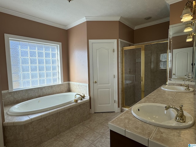 bathroom with a textured ceiling, plus walk in shower, vanity, and tile patterned flooring