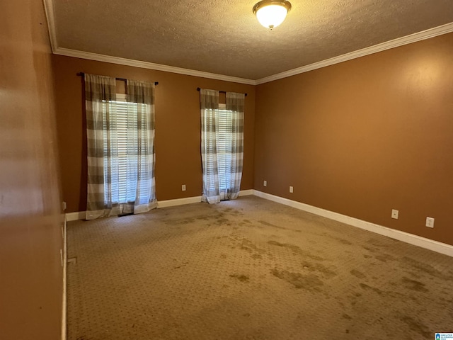 unfurnished room with a textured ceiling, carpet floors, and crown molding