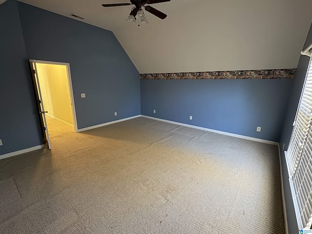 additional living space featuring ceiling fan, carpet, a healthy amount of sunlight, and lofted ceiling