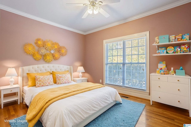 bedroom featuring ceiling fan, hardwood / wood-style flooring, and multiple windows