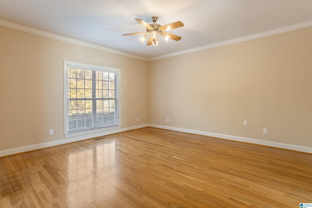 spare room with crown molding, light wood-type flooring, and ceiling fan