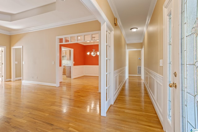 hall featuring light hardwood / wood-style floors and ornamental molding