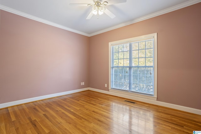 empty room with ornamental molding, hardwood / wood-style flooring, and ceiling fan