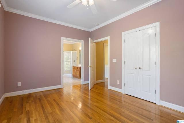 unfurnished bedroom featuring crown molding, hardwood / wood-style flooring, a closet, and ceiling fan