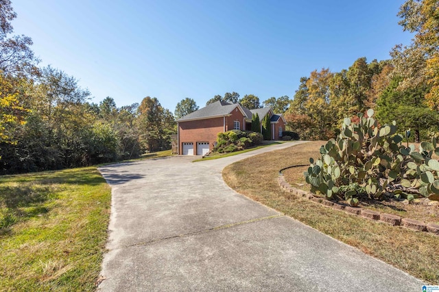 exterior space featuring a garage and a front lawn