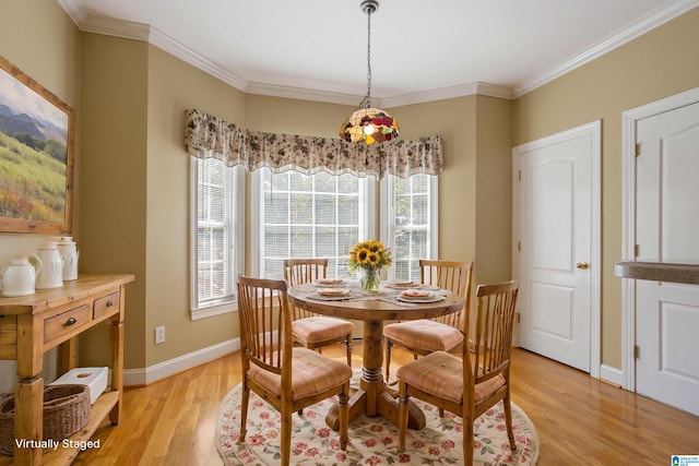 dining space featuring crown molding, a healthy amount of sunlight, and light wood-type flooring