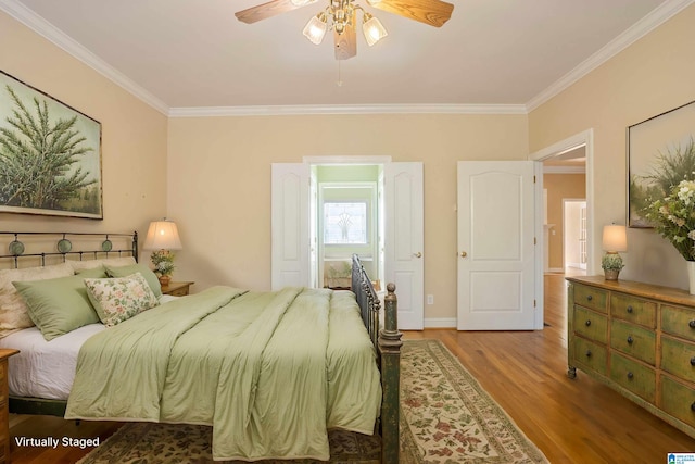 bedroom featuring crown molding, hardwood / wood-style floors, and ceiling fan