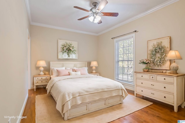 bedroom with crown molding, light hardwood / wood-style floors, and ceiling fan