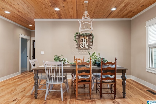 dining room with ornamental molding, light hardwood / wood-style flooring, and wood ceiling