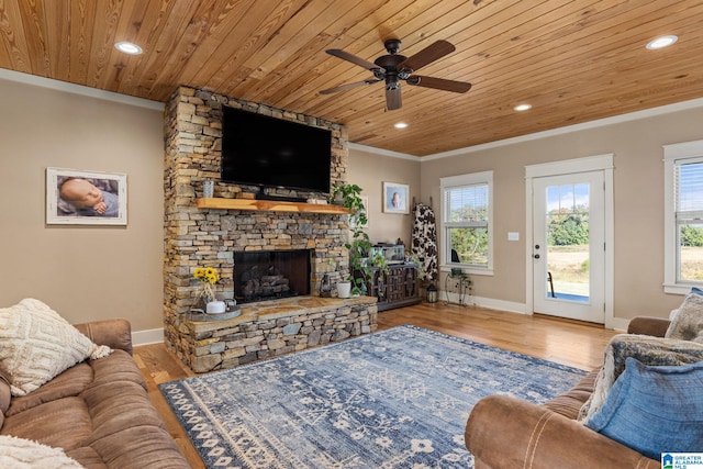 living room featuring wooden ceiling, a fireplace, light wood-type flooring, and plenty of natural light