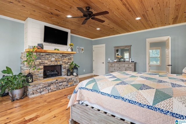 bedroom with ornamental molding, wood ceiling, hardwood / wood-style floors, and a fireplace