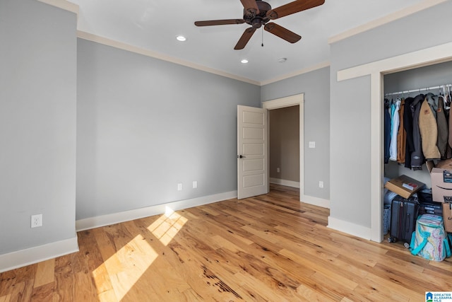 unfurnished bedroom featuring ornamental molding, light wood-type flooring, a closet, and ceiling fan