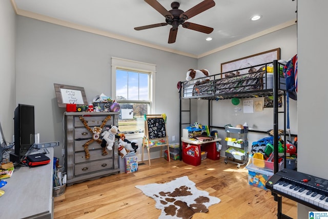 bedroom with ornamental molding, hardwood / wood-style floors, and ceiling fan