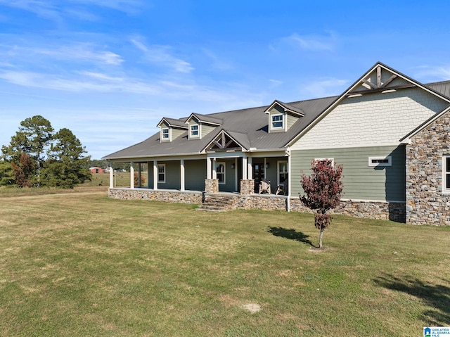 craftsman inspired home featuring covered porch and a front yard