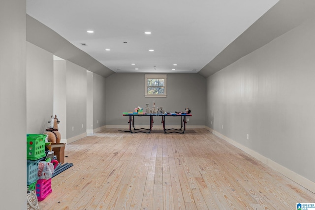 playroom with lofted ceiling and light hardwood / wood-style flooring