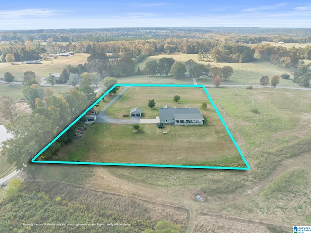 birds eye view of property with a rural view