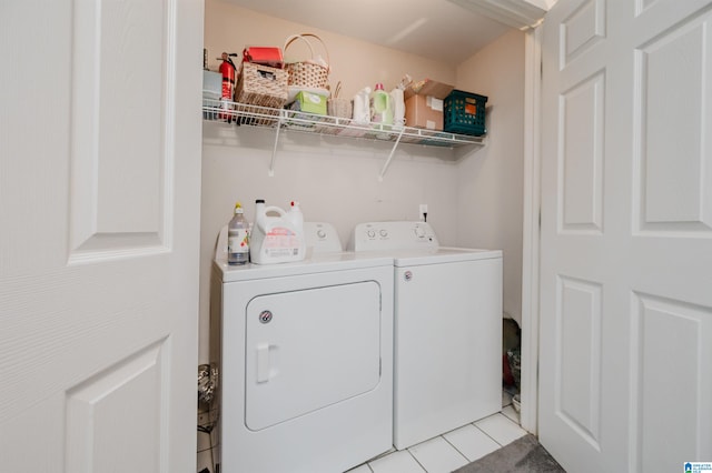 washroom with light tile patterned flooring and washing machine and clothes dryer