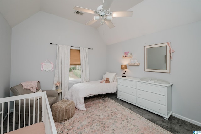 bedroom with ceiling fan, vaulted ceiling, and dark colored carpet