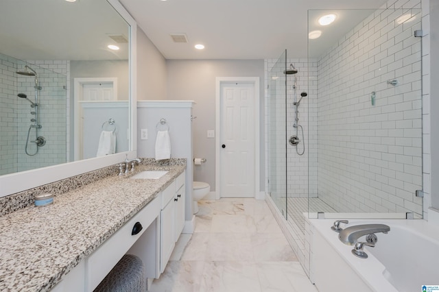 full bathroom featuring toilet, vanity, and separate shower and tub