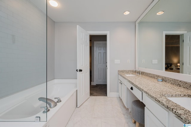 bathroom featuring vanity and a tub