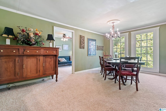 carpeted dining area with ornamental molding and ceiling fan with notable chandelier