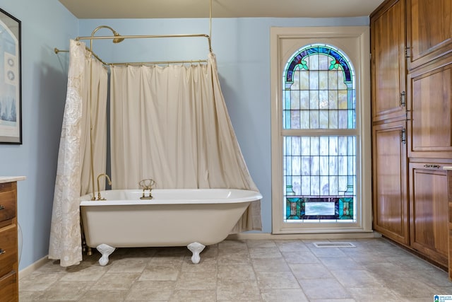 bathroom with vanity and a tub to relax in