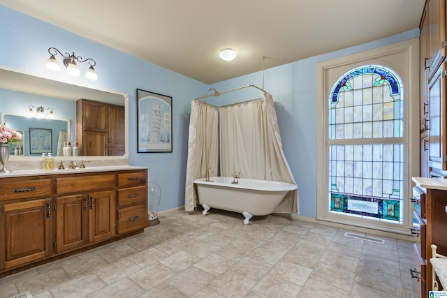 bathroom with vanity and separate shower and tub