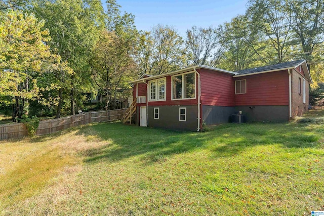 view of property exterior with cooling unit and a yard