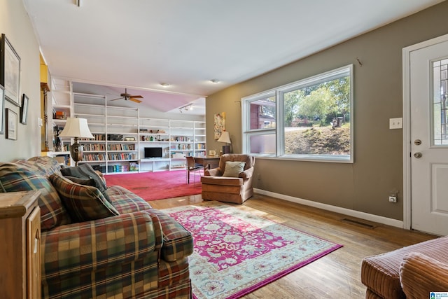 living room featuring light hardwood / wood-style floors and ceiling fan