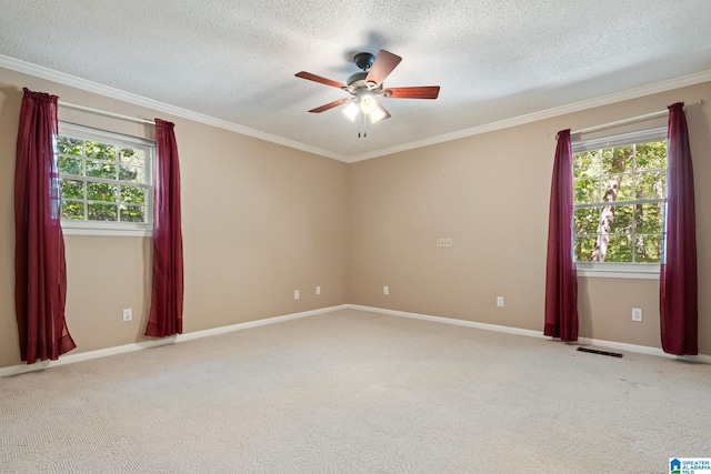 carpeted spare room with crown molding, a textured ceiling, and ceiling fan