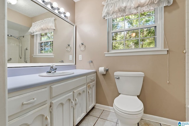 bathroom with vanity, toilet, tile patterned flooring, and a shower with door