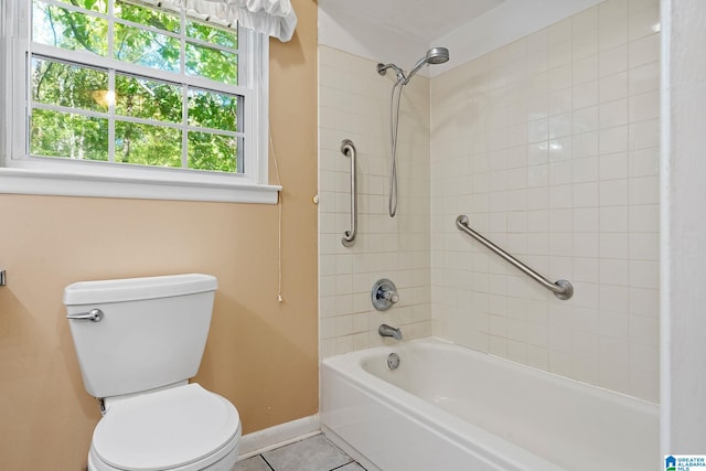 bathroom featuring toilet, tiled shower / bath, and tile patterned floors