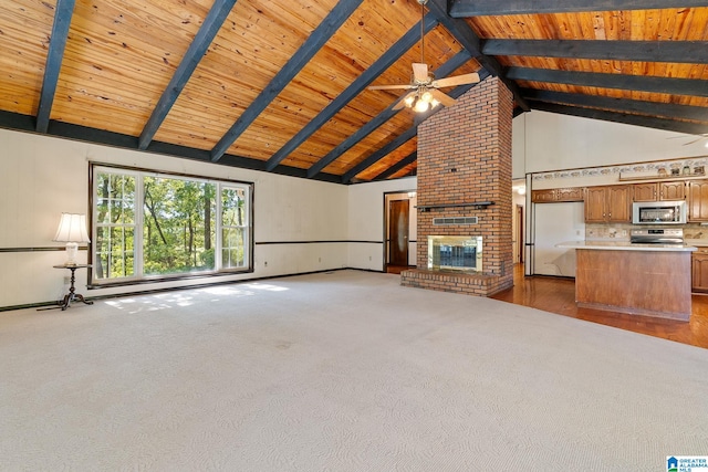 unfurnished living room with beamed ceiling, hardwood / wood-style floors, a fireplace, high vaulted ceiling, and ceiling fan