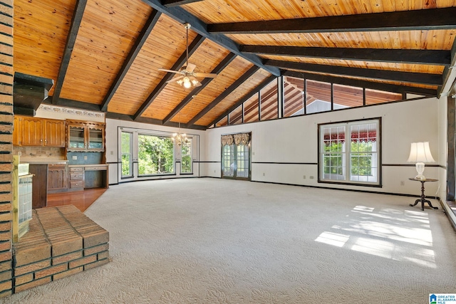 unfurnished living room featuring beamed ceiling, wood ceiling, light colored carpet, and ceiling fan with notable chandelier