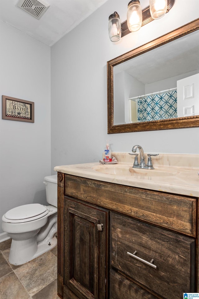 bathroom with vanity and toilet