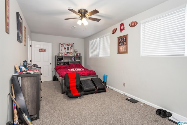 bedroom featuring ceiling fan and carpet