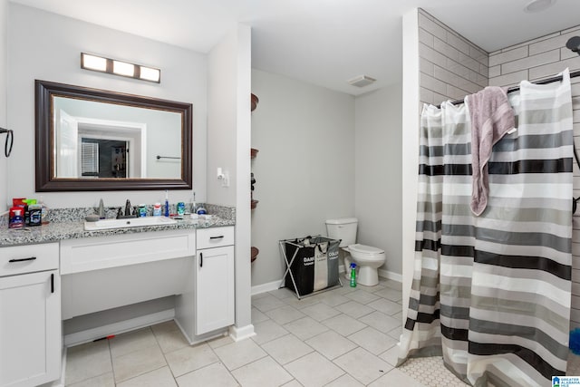 bathroom with vanity, a shower with curtain, toilet, and tile patterned flooring