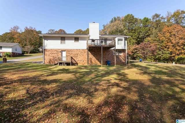 rear view of property featuring a yard and a deck