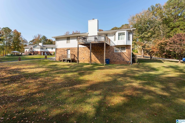 rear view of property featuring a yard and a deck