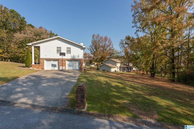 view of front of home with a front yard and a garage