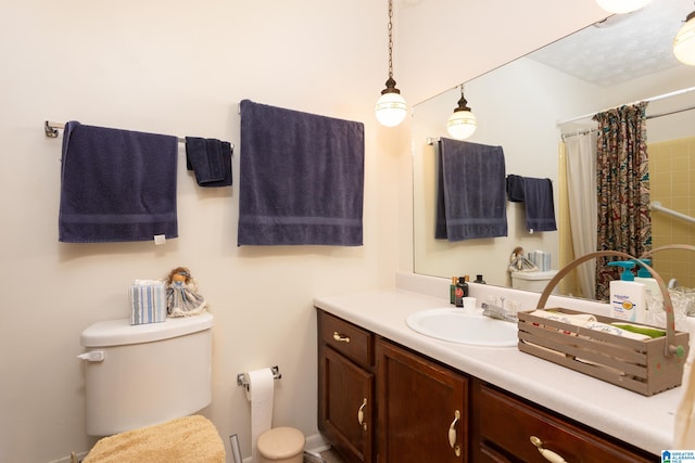 bathroom featuring vanity, a shower with shower curtain, and toilet